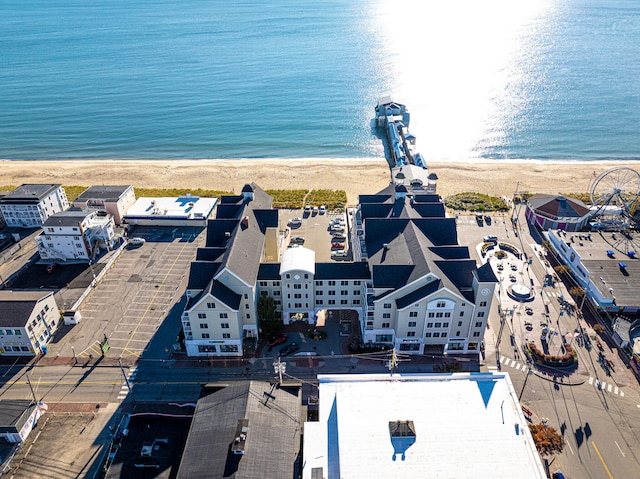 drone / aerial view with a water view and a beach view