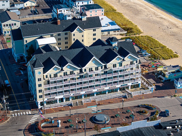 aerial view featuring a view of the beach and a water view