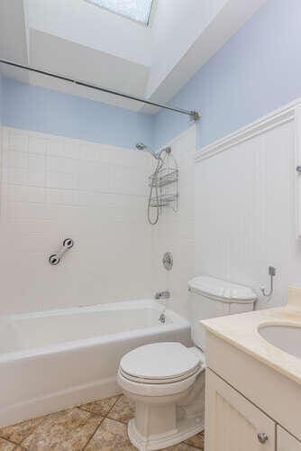 full bathroom featuring vanity, tile patterned floors, shower / bathtub combination, and toilet