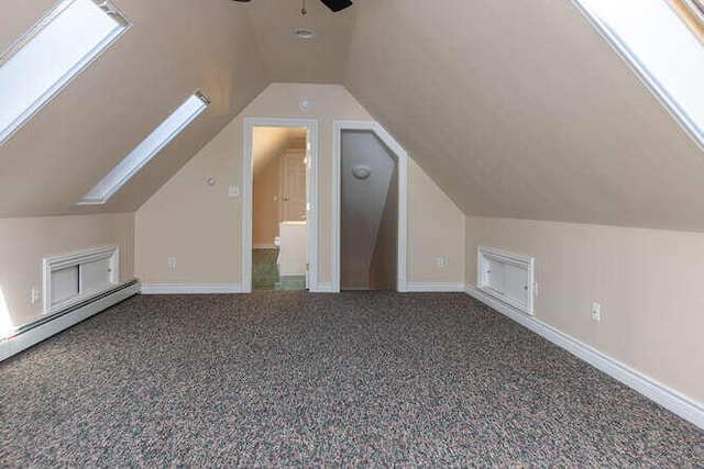 bonus room featuring lofted ceiling with skylight, ceiling fan, and carpet flooring