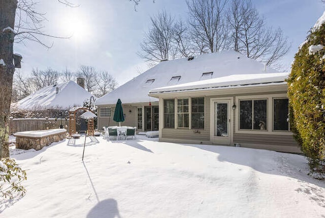 view of snow covered back of property