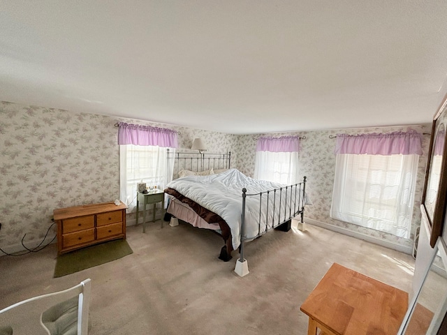 bedroom featuring carpet flooring and multiple windows