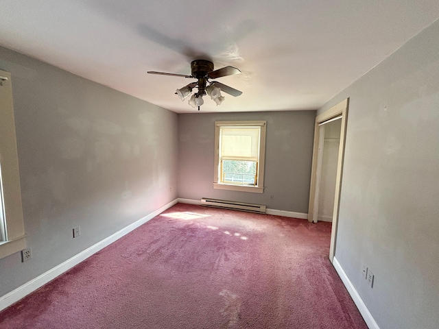 carpeted empty room featuring baseboard heating and ceiling fan