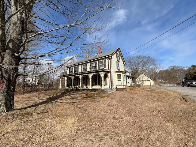 77 Fletcher St, Kennebunk, ME 04043 - view of front of property with a garage, a chimney, and a porch