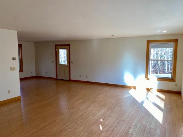 unfurnished living room with light hardwood / wood-style floors and a wealth of natural light