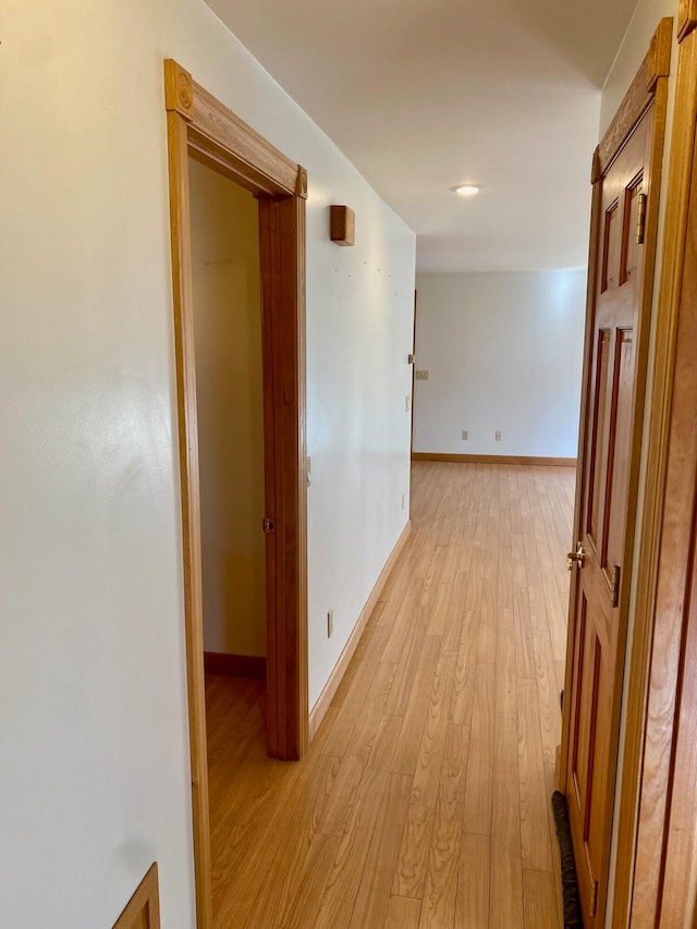 hallway with light hardwood / wood-style flooring