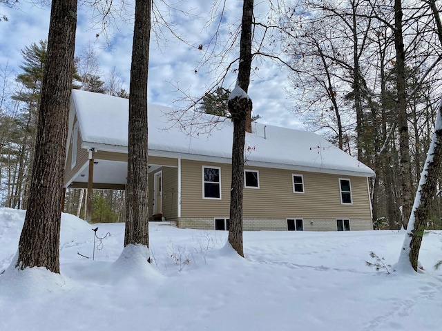 view of snow covered rear of property