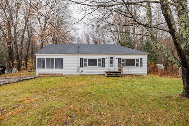 rear view of property with a lawn