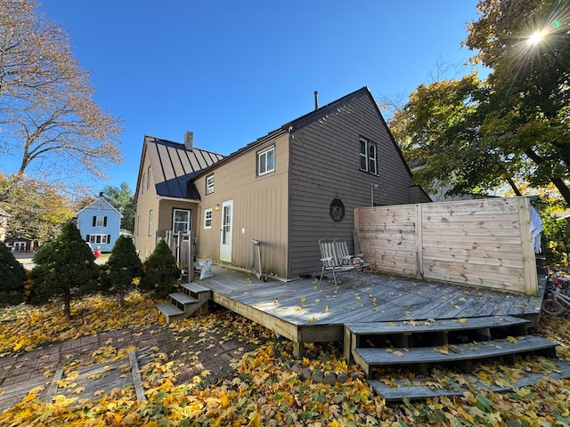 rear view of property with a wooden deck