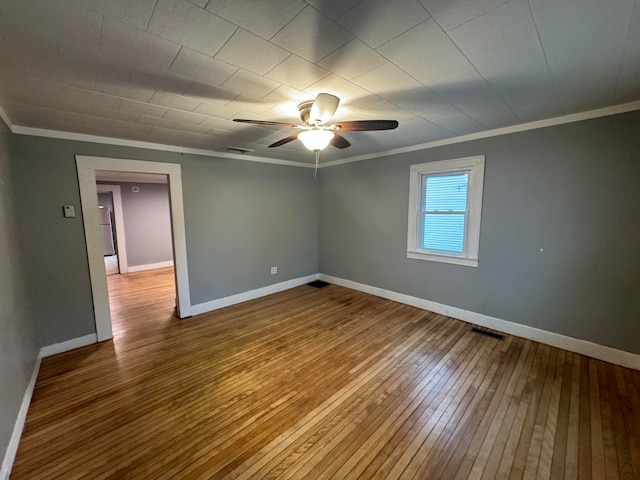 unfurnished room with ornamental molding, wood-type flooring, and ceiling fan