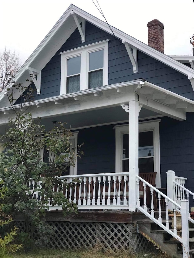 view of exterior entry with a porch