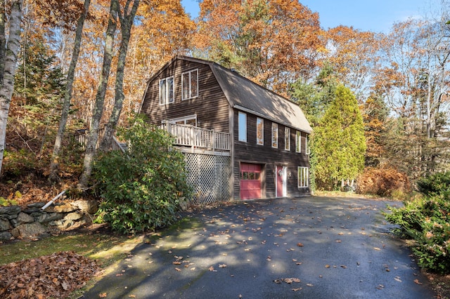 view of home's exterior featuring a garage and a wooden deck