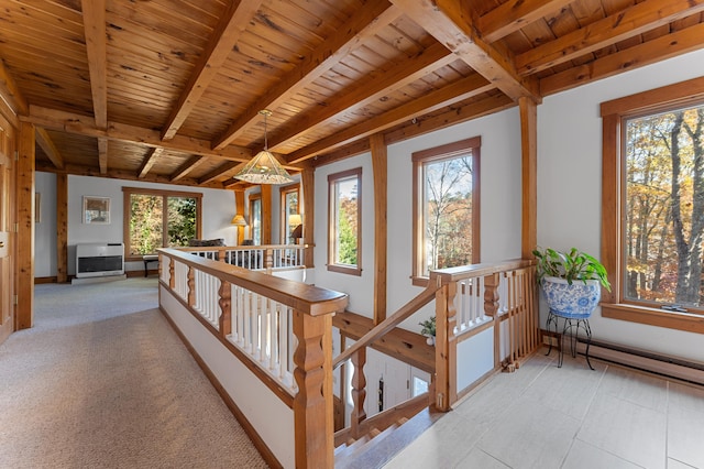 hall featuring a healthy amount of sunlight and wood ceiling