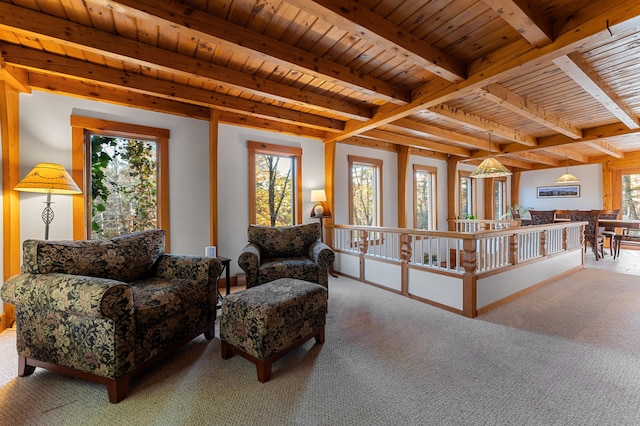 carpeted living room with beamed ceiling, a wealth of natural light, and wooden ceiling