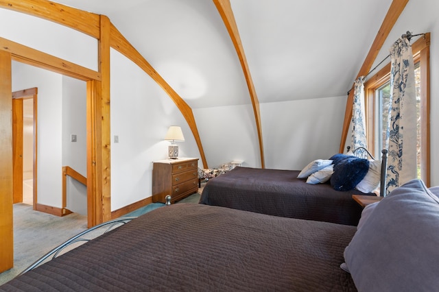 carpeted bedroom featuring vaulted ceiling with beams