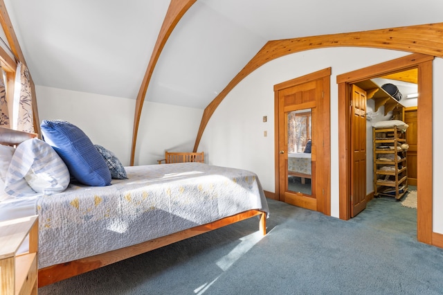 bedroom featuring lofted ceiling and carpet