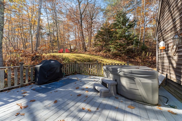 wooden terrace with a hot tub and grilling area