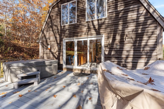 wooden deck featuring a hot tub