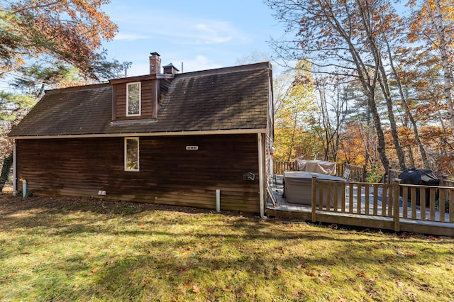 rear view of property with a lawn and a wooden deck