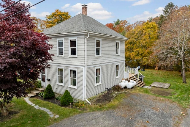 view of property exterior featuring a lawn