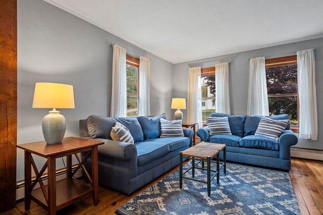 living room with dark hardwood / wood-style floors, baseboard heating, and ornamental molding