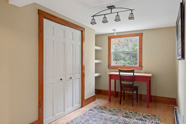 office area with baseboard heating and light hardwood / wood-style floors