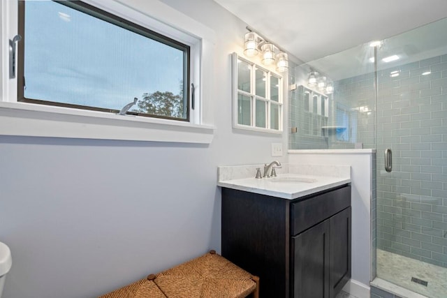 bathroom with vanity and a shower with shower door