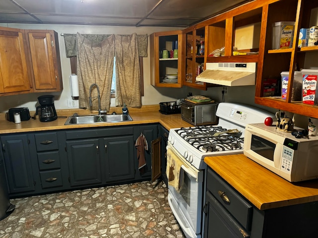 kitchen with sink, white appliances, and a paneled ceiling