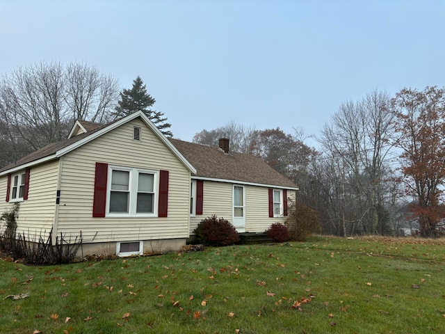 view of side of home with a lawn