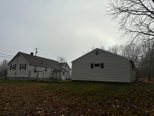 view of side of home featuring a lawn