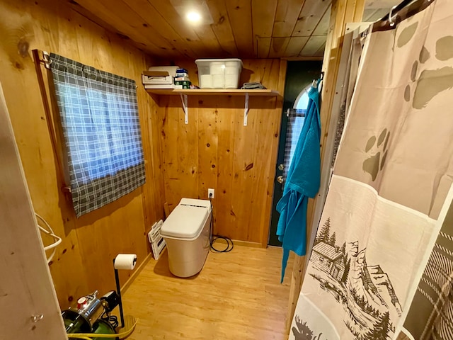 bathroom with wood ceiling, a shower with curtain, wooden walls, and wood-type flooring