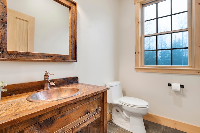 bathroom with vanity, toilet, and tile patterned floors