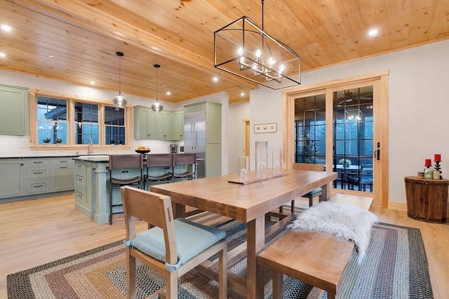 dining area with wood ceiling, sink, a notable chandelier, and light wood-type flooring