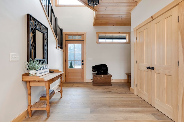 entryway with wood ceiling and light wood-type flooring