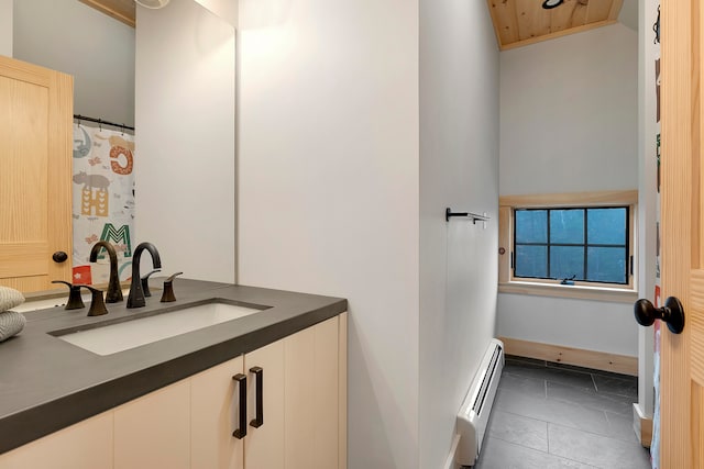 bathroom with vanity, a baseboard radiator, and tile patterned flooring