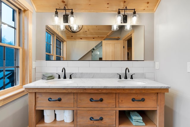 bathroom featuring vanity and backsplash