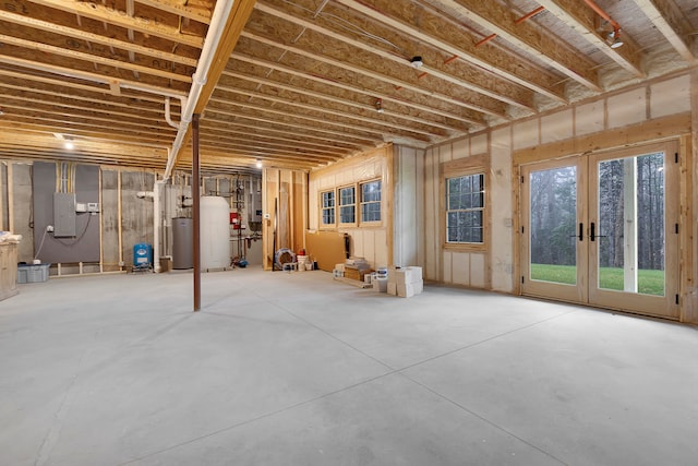 basement featuring french doors, electric panel, and gas water heater