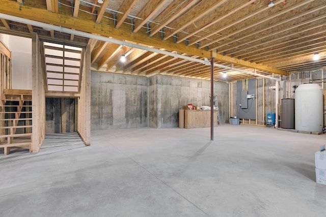 basement featuring gas water heater and electric panel