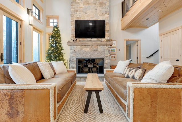 living room featuring a towering ceiling and a fireplace