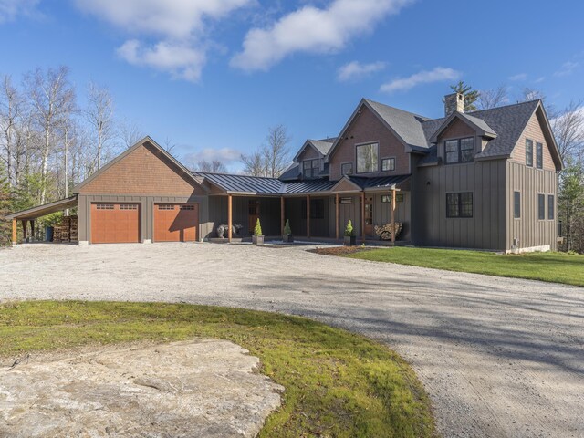 100 Morganite Way, Newry, ME 04261 - view of front of home with a standing seam roof, board and batten siding, driveway, and a garage