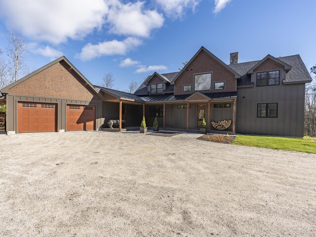 100 Morganite Way, Newry, ME 04261 - view of front of property featuring board and batten siding, a standing seam roof, dirt driveway, and a garage