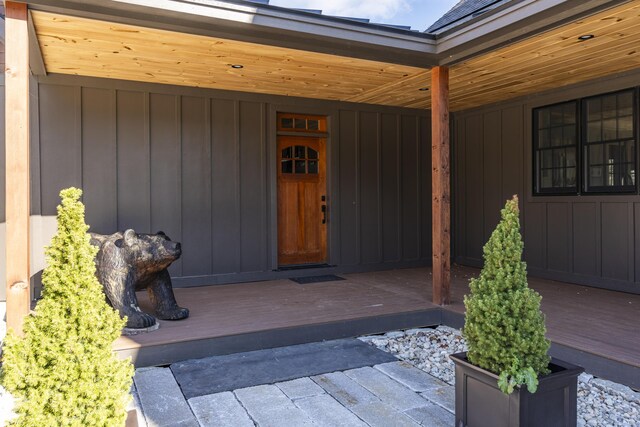 100 Morganite Way, Newry, ME 04261 - doorway to property featuring board and batten siding, a wooden deck, and a patio area
