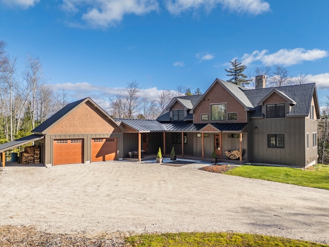 view of front of house with a porch, a front lawn, and a garage