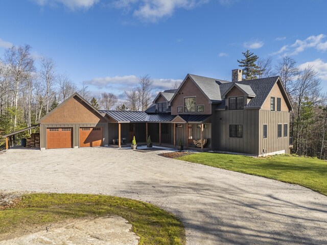 100 Morganite Way, Newry, ME 04261 - view of front of home with board and batten siding, a standing seam roof, dirt driveway, a front yard, and a chimney