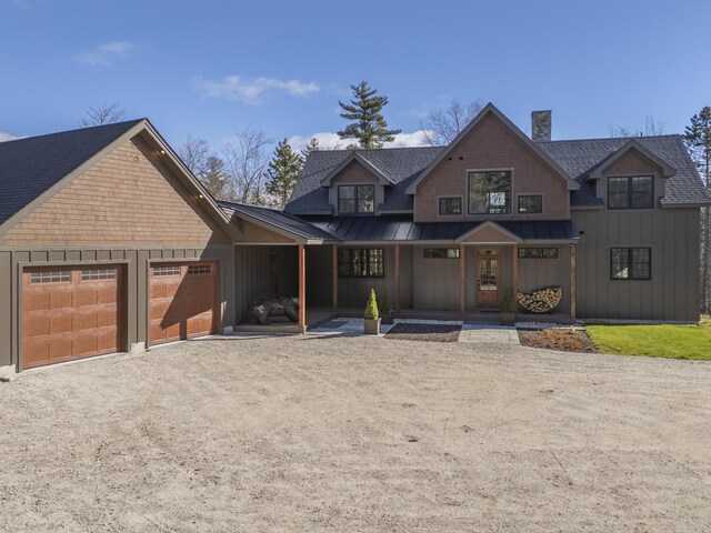 100 Morganite Way, Newry, ME 04261 - view of front of house with a shingled roof, driveway, a standing seam roof, a chimney, and an attached garage