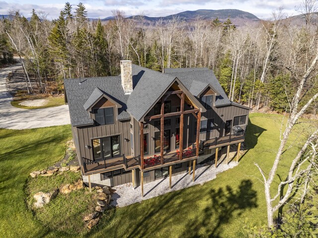 100 Morganite Way, Newry, ME 04261 - back of house with a yard, board and batten siding, a deck with mountain view, and a shingled roof