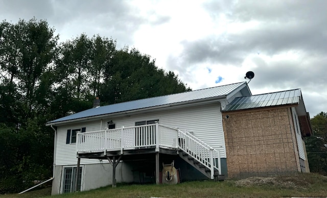 back of property featuring a deck