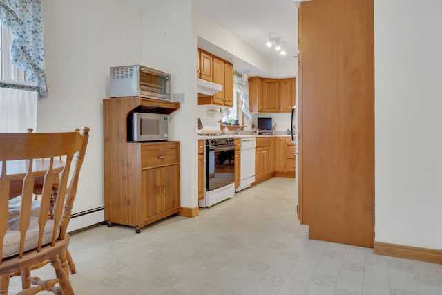 kitchen with ventilation hood, track lighting, and white appliances