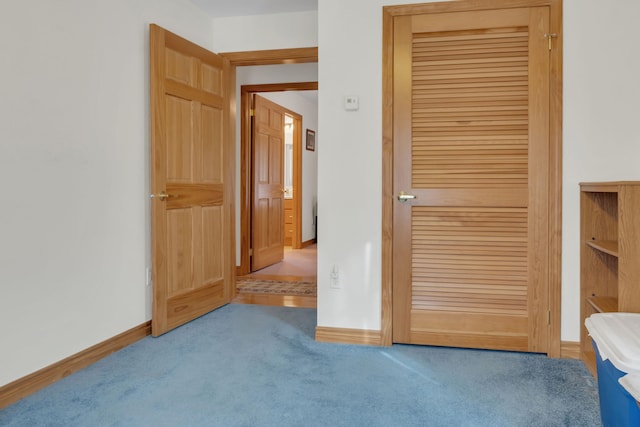 interior space with a closet and light colored carpet