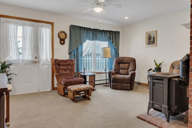 sitting room featuring carpet floors, a healthy amount of sunlight, and ceiling fan